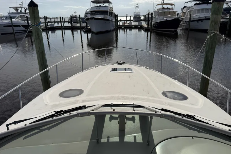 Slide: The Image of 2006 Sea Ray Sundancer 320 docked at marina with other boats in background. - 26
