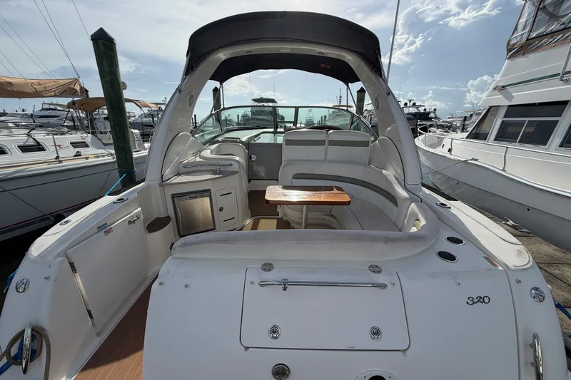 Slide: The Image of 2006 Sea Ray Sundancer 320 yacht interior with seating and table, docked at marina. - 32
