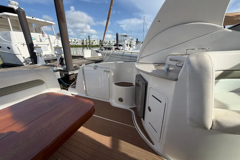 Slide: The Image of 2006 Sea Ray Sundancer 320 yacht interior with wooden table and seating at marina. - 37