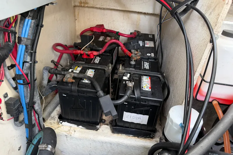 Slide: The Image of Battery compartment of a 2006 Sea Ray Sundancer 320 boat with wiring and connections. - 104