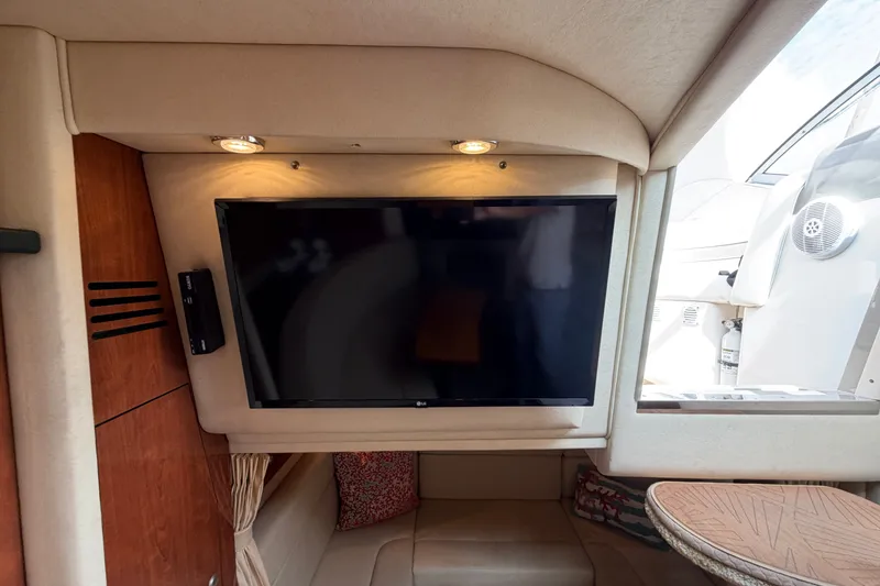 Slide: The Image of Interior of 2006 Sea Ray Sundancer 320 with mounted TV and cozy seating area. - 79