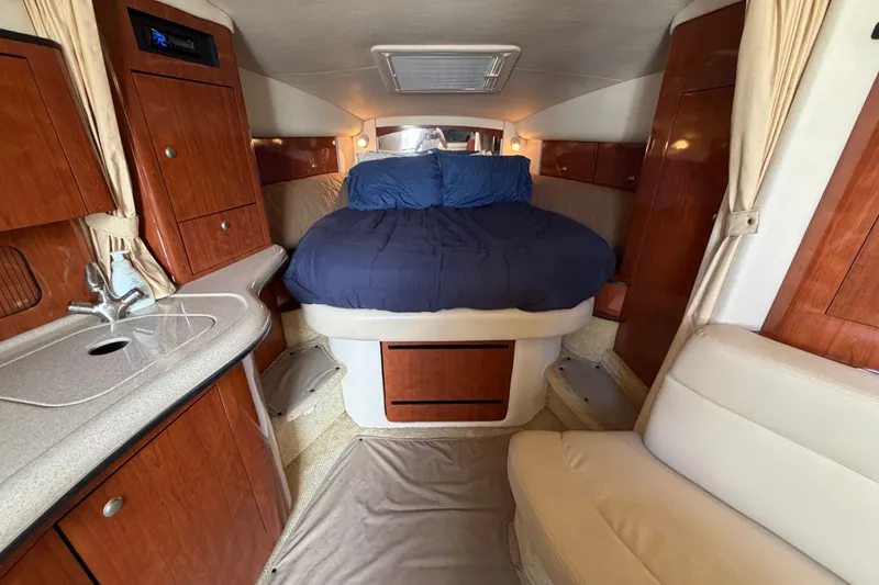 Slide: The Image of Luxurious interior of 2006 Sea Ray Sundancer 320 with cozy bed and wooden cabinetry. - 60