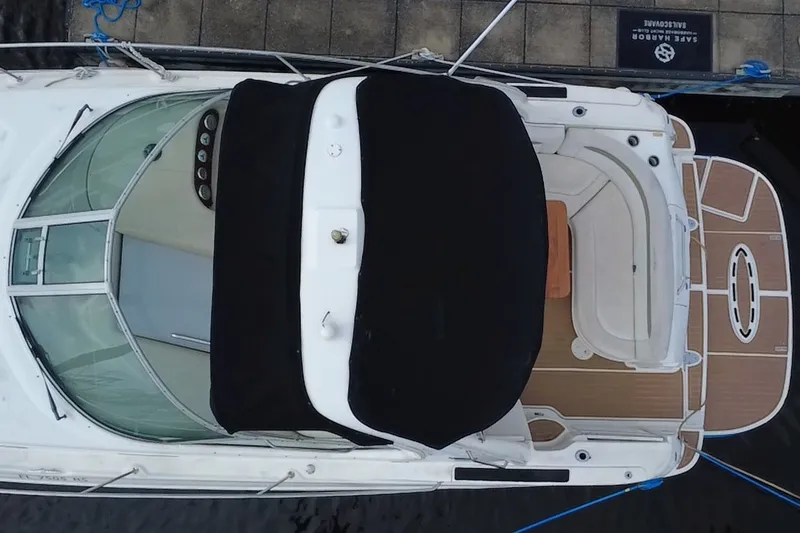 Slide: The Image of Overhead view of a 2006 Sea Ray Sundancer 320 docked, showcasing its sleek design and spacious deck. - 13
