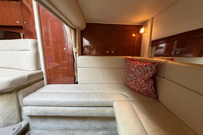 Slide: The Image of Interior of 2006 Sea Ray Sundancer 320 with beige seating and red decorative pillow. - 93