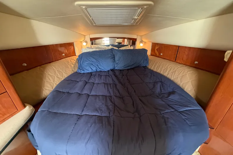 Slide: The Image of Cozy cabin bedroom in 2006 Sea Ray Sundancer 320 yacht with blue bedding. - 63