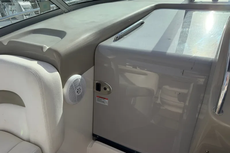 Slide: The Image of Interior view of a 2006 Sea Ray Sundancer 320 boat, featuring seating and a speaker. - 44