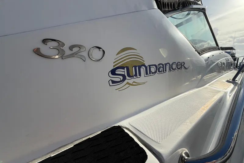 Slide: The Image of 2006 Sea Ray Sundancer 320 boat logo and model detail in sunlight. - 19