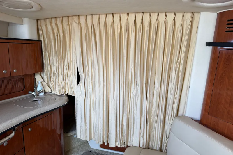 Slide: The Image of Interior of 2006 Sea Ray Sundancer 320 with beige curtains and wooden cabinetry. - 91