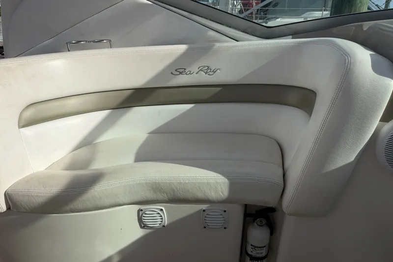 Slide: The Image of Interior seating of a 2006 Sea Ray Sundancer 320 boat, featuring white upholstery. - 43