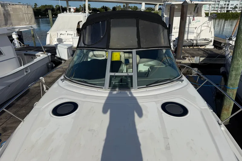 Slide: The Image of 2006 Sea Ray Sundancer 320 docked at marina, featuring sleek design and spacious deck. - 24