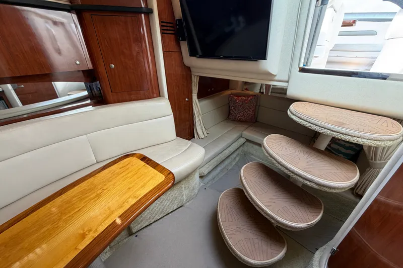 Slide: The Image of Interior of 2006 Sea Ray Sundancer 320 yacht with seating, table, and stairs. - 64