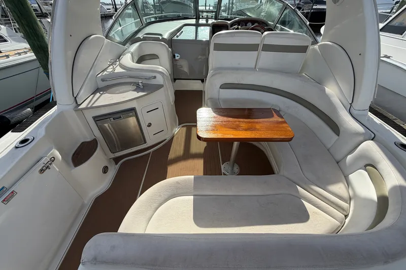 Slide: The Image of 2006 Sea Ray Sundancer 320 interior with seating, table, and kitchenette. - 33