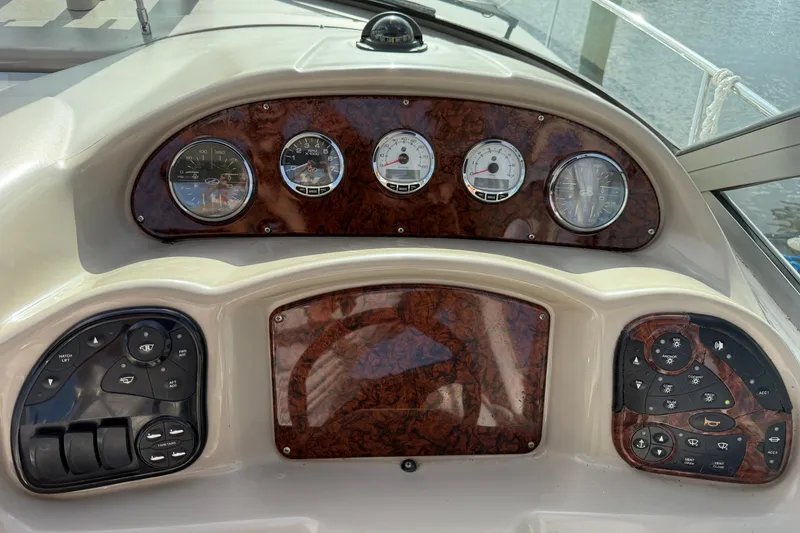 Slide: The Image of Dashboard of a 2006 Sea Ray Sundancer 320 boat with gauges and controls. - 46