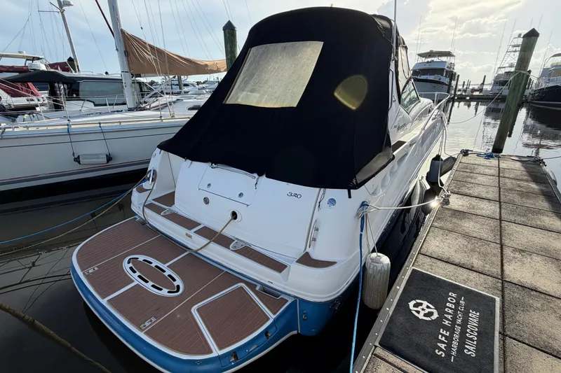 Slide: The Image of 2006 Sea Ray Sundancer 320 docked at marina, rear view with black cover. - 14