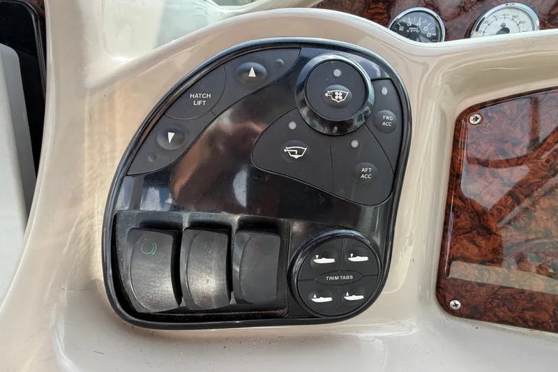 Slide: The Image of Control panel of a 2006 Sea Ray Sundancer 320 boat with various switches and dials. - 58