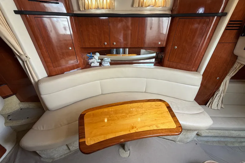 Slide: The Image of Interior of 2006 Sea Ray Sundancer 320 with curved seating and wooden table. - 75
