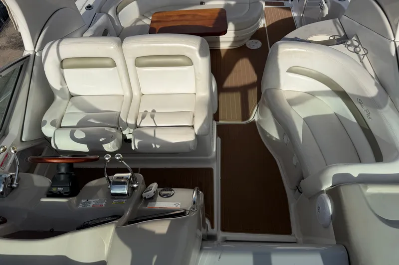 Slide: The Image of 2006 Sea Ray Sundancer 320 interior with white seating and wooden accents. - 47
