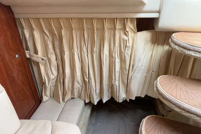 Slide: The Image of Interior of 2006 Sea Ray Sundancer 320 with beige curtains and wooden accents. - 89