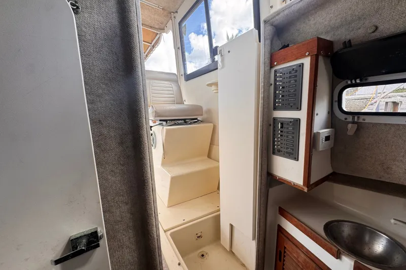 Slide: The Image of Interior view of 2005 Atlas Boat Works Acadia 25, featuring seating and control panel. - 40