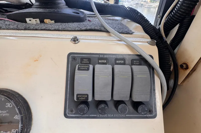 Slide: The Image of Control panel of a 2005 Atlas Boat Works Acadia 25 with switches and gauges. - 17