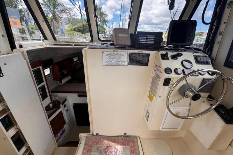 Slide: The Image of Interior view of 2005 Atlas Boat Works Acadia 25 helm with steering wheel and navigation equipment. - 12