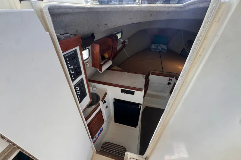 Slide: The Image of Interior view of 2005 Atlas Boat Works Acadia 25, featuring cabin amenities and control panel. - 26