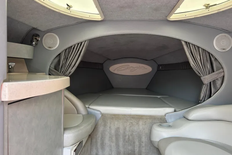 Slide: The Image of Interior cabin of a 2005 Baha Cruisers 302 boat, featuring seating and a sleeping area. - 47