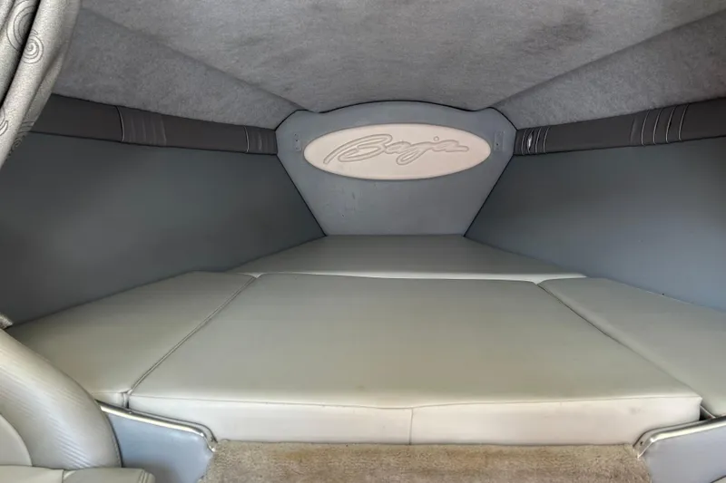 Slide: The Image of Interior cabin of a 2005 Baha Cruisers 302 boat, featuring cushioned seating. - 53