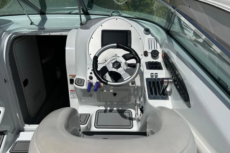 Slide: The Image of 2005 Baha Cruisers 302 boat cockpit with steering wheel and control panel. - 31