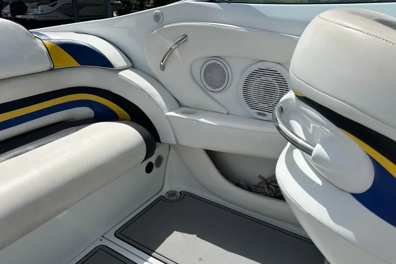 Slide: The Image of Interior of a 2005 Baha Cruisers 302 boat with white seating and colorful accents. - 64