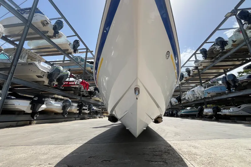Slide: The Image of 2005 Baha Cruisers 302 boat stored in a multi-level marina rack under a clear sky. - 15