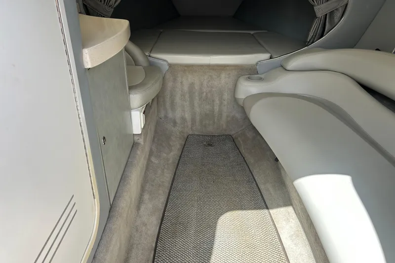 Slide: The Image of Interior cabin of 2005 Baha Cruisers 302 boat, featuring seating and carpeted flooring. - 44