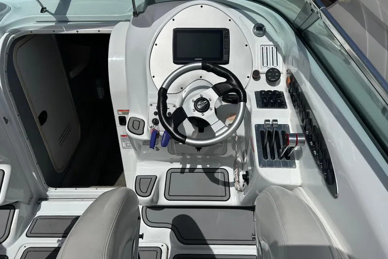 Slide: The Image of Cockpit of 2005 Baha Cruisers 302 boat with steering wheel and control panel. - 32
