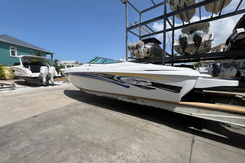 Slide: The Image of Een Baha Cruisers 302 boot uit 2005 op een trailer in een havengebied. - 1