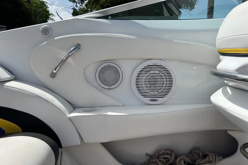 Slide: The Image of Interior of a 2005 Baha Cruisers 302 boat featuring speakers and seating. - 65