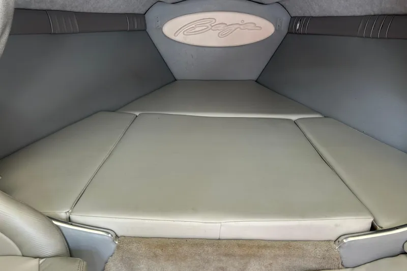 Slide: The Image of Interior cabin of a 2005 Baha Cruisers 302 boat, featuring cushioned seating. - 54