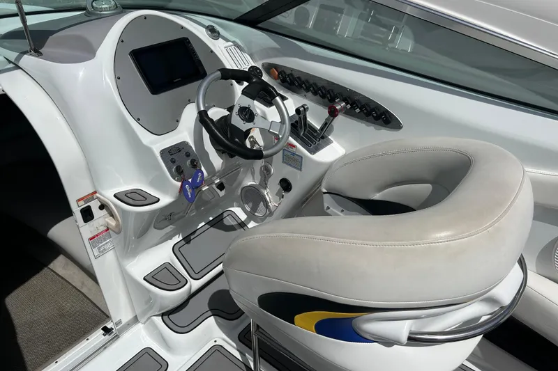 Slide: The Image of Helm of 2005 Baha Cruisers 302 boat with steering wheel and control panel. - 30