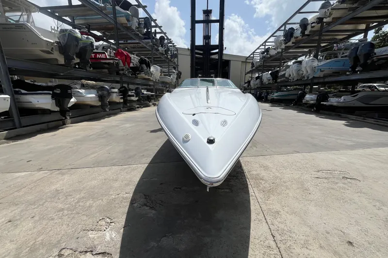 Slide: The Image of 2005 Baha Cruisers 302 boat in storage facility, surrounded by other boats. - 13