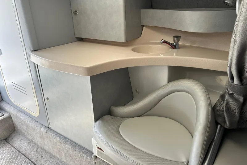 Slide: The Image of 2005 Baha Cruisers 302 boat interior with sink, countertop, and cushioned seat. - 52