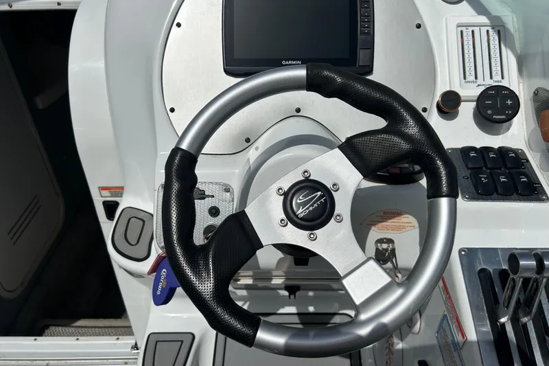 Slide: The Image of Steering wheel and controls of a 2005 Baha Cruisers 302 boat cockpit. - 34