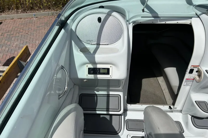 Slide: The Image of Interior view of a 2005 Baha Cruisers 302 boat, featuring seating and cabin entrance. - 25