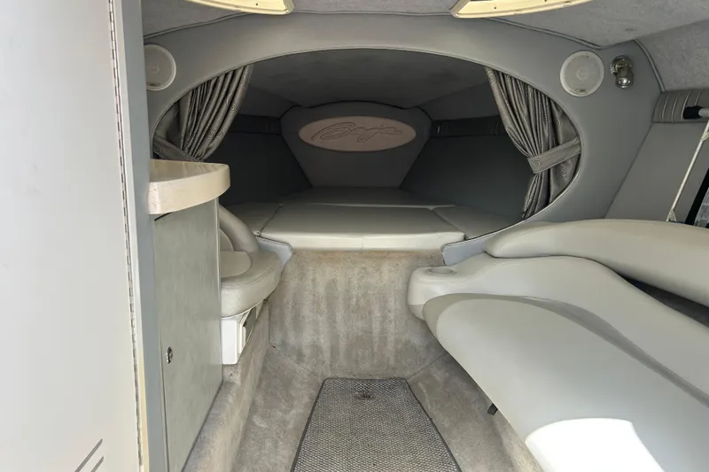 Slide: The Image of Interior cabin of a 2005 Baha Cruisers 302 boat, featuring seating and sleeping area. - 41
