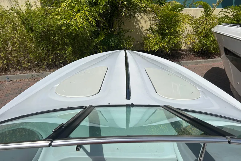 Slide: The Image of 2005 Baha Cruisers 302 boat deck with windshield, surrounded by greenery. - 39