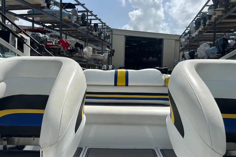 Slide: The Image of Interior of a 2005 Baha Cruisers 302 boat with white and blue seating. - 60