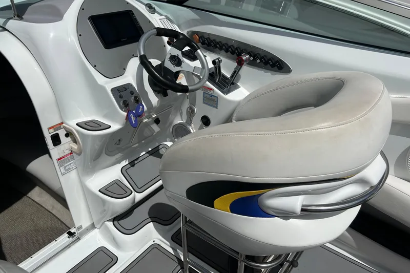 Slide: The Image of 2005 Baha Cruisers 302 boat cockpit with steering wheel and control panel. - 29