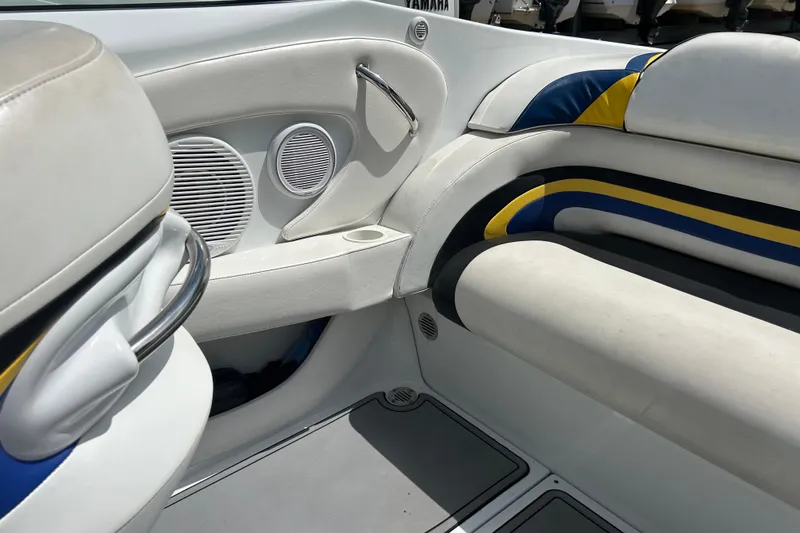 Slide: The Image of Interior of a 2005 Baha Cruisers 302 boat with white and blue seating. - 63