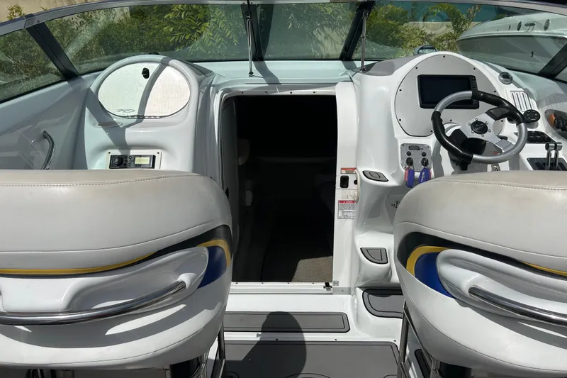 Slide: The Image of Interior view of a 2005 Baha Cruisers 302 boat cockpit with steering wheel and controls. - 21