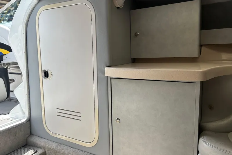 Slide: The Image of Interior cabin of a 2005 Baha Cruisers 302 boat, featuring storage cabinets and seating. - 45
