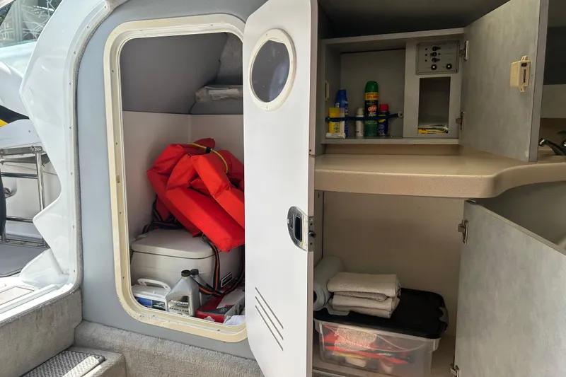 Slide: The Image of Interior storage of a 2005 Baha Cruisers 302 boat with life jackets and supplies. - 46