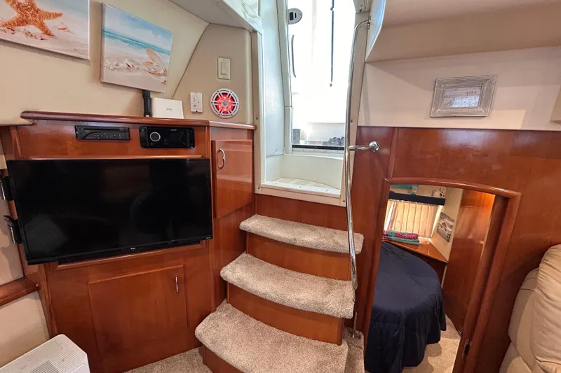 Slide: The Image of Interior of 2005 Carver 36 Motor Yacht with TV, stairs, and cozy cabin. - 135
